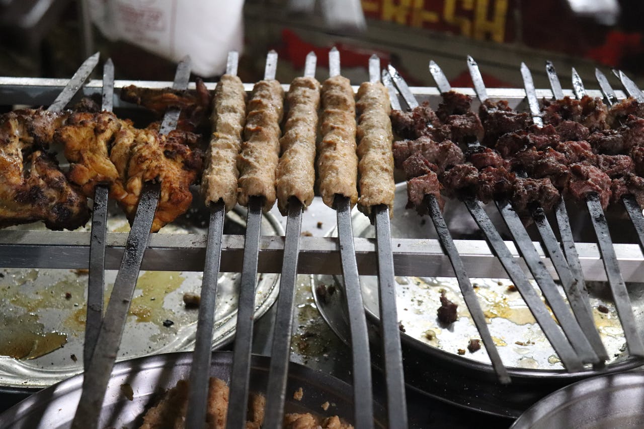 Grilled chapli and seekh kabobs on skewers